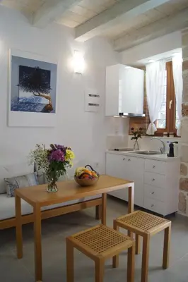 a kitchen with a table and chairs and a sink at Casa al Bocca del Porto in Chania Town
