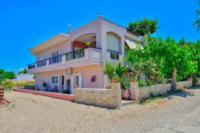 a large house with a fence in front of it at Eliana in Kissamos