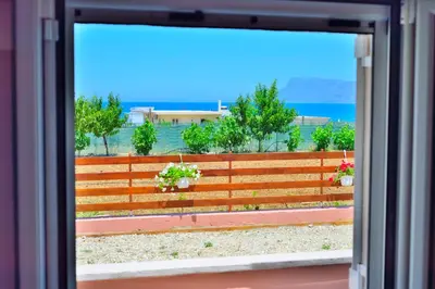 a window view of a fence with potted plants at Eliana in Kissamos