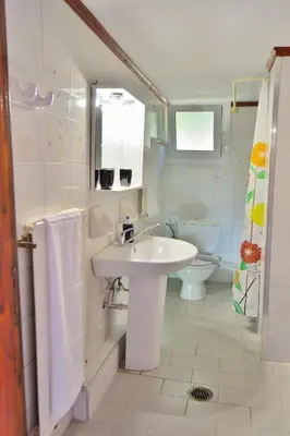 a white bathroom with a sink and a toilet at Eliana in Kissamos