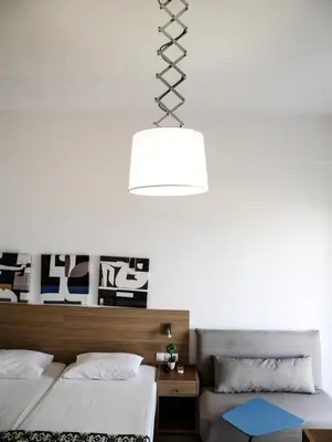 a bedroom with two beds and a white wall at Georgia in Palaiochóra
