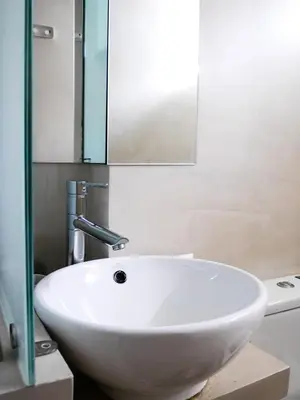 a white sink in a bathroom with a mirror at Georgia in Palaiochóra
