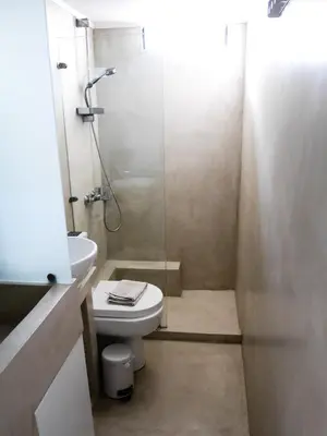 a bathroom with a toilet and a glass shower at Georgia in Palaiochóra