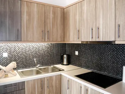 a kitchen with wooden cabinets and a sink at Georgia in Palaiochóra