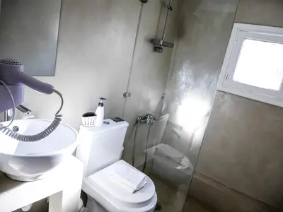 a bathroom with a toilet and a sink and a shower at Georgia in Palaiochóra