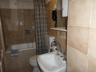 a small bathroom with a toilet and a sink at Tina Hotel in Chania Town
