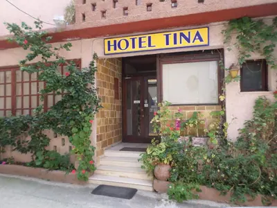 a hotel with a sign on the front of a building at Tina Hotel in Chania Town