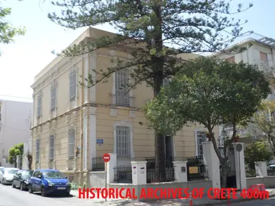 a building with a tree in front of it at Tina Hotel in Chania Town