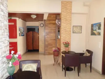 a living room with a table and chairs at Tina Hotel in Chania Town
