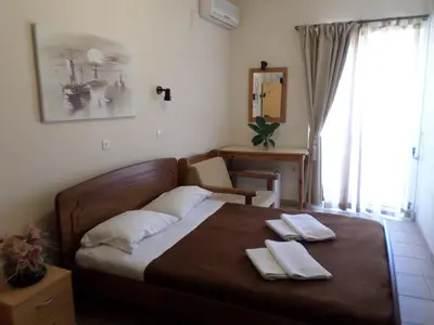 a bedroom with a bed with two towels on it at Tina Hotel in Chania Town