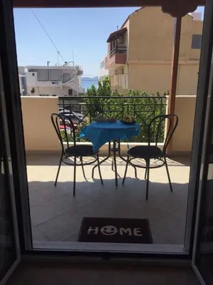 a view of a table and chairs from a window at The Endless Blue Maisonette in Palaiochóra