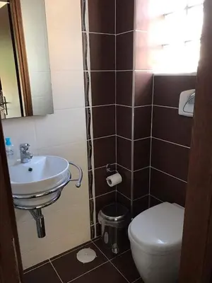 a bathroom with a sink and a toilet at The Endless Blue Maisonette in Palaiochóra