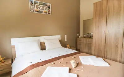 a bedroom with a large bed with towels on it at Xirouchakis farm in Kissamos