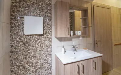 a bathroom with a sink and a mirror at Xirouchakis farm in Kissamos