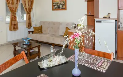 a living room with a table with a vase of flowers at Xirouchakis farm in Kissamos