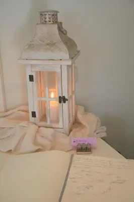 a lantern on top of a table with a piece of paper at Waterlily Hotel Apartments in Kalathas