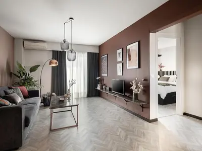 a living room with a couch and a tv at TESSERA Urban Chania in Chania Town