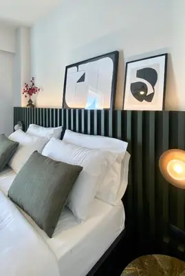 a bedroom with a bed with white pillows at TESSERA Urban Chania in Chania Town