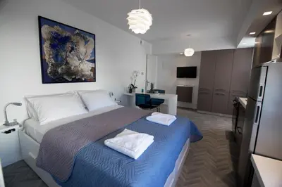 a bedroom with a bed with two towels on it at DYO Urban Chania in Chania Town