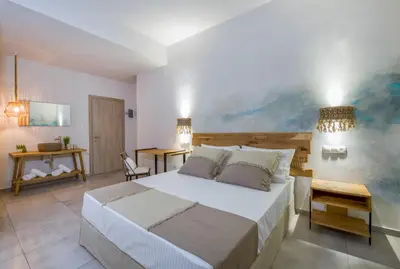 a bedroom with a bed and a painting on the wall at Eleana Nature & Art in Khóra Sfakíon
