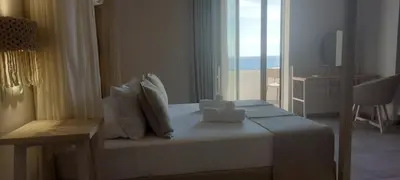 a bedroom with a bed with a view of the ocean at Eleana Nature & Art in Khóra Sfakíon