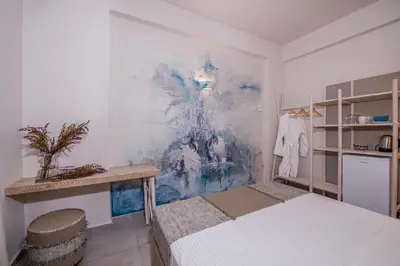 a bedroom with a bed and a painting on the wall at Eleana Nature & Art in Khóra Sfakíon