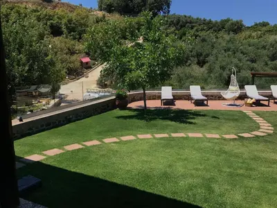 a park with a group of chairs and a tree at Villa Casa Avocado in Tavronitis