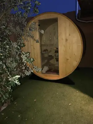 a wooden barrel sitting on the grass in a room at Villa Casa Avocado in Tavronitis
