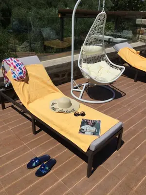 a hammock and a chair on a deck at Villa Casa Avocado in Tavronitis