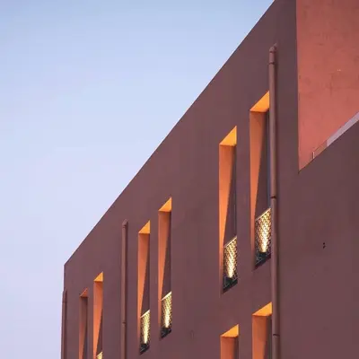 a building with lights in the windows of it at Avra Apartments Venetian Harbour in Chania Town