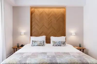 a bedroom with a white bed with two pillows at Avra Apartments Venetian Harbour in Chania Town