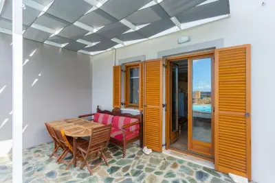 a dining room with a table and a chair at Villa Konstantina in Exopoli