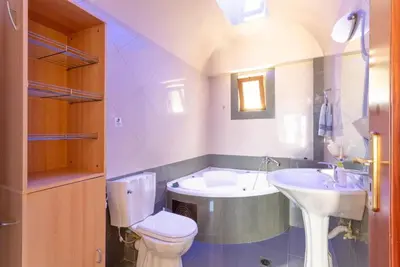 a bathroom with a toilet and a sink and a tub at Souda Bay View in Kalami