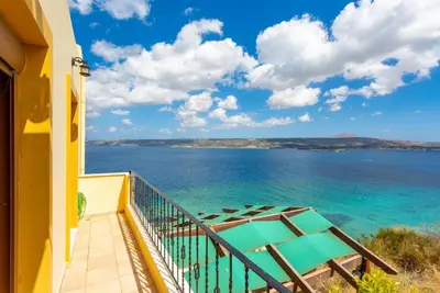 a balcony with a view of the ocean at Souda Bay View in Kalami