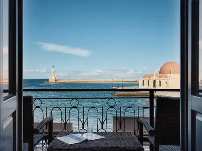 a table with a view of the ocean and a lighthouse at Domus Fresco in Chania Town