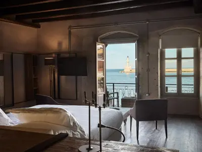 a bedroom with a bed and a view of the ocean at Domus Fresco in Chania Town