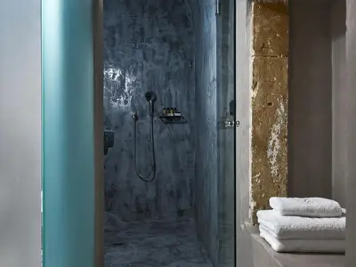 a bathroom with a shower with a glass door at Domus Fresco in Chania Town
