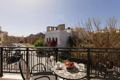 a table with a bowl of fruit on a balcony at Nival Luxury Suites in Chania Town