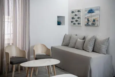 a living room with a couch and chairs and a table at Shalom Luxury Rooms Daliani in Chania Town