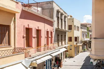 an alley in an old town with pink buildings at Shalom Luxury Rooms Daliani in Chania Town