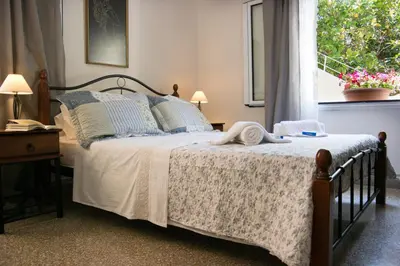 a bedroom with a large bed with a window at Alexandra Apartment Near Chania Center in Chania Town