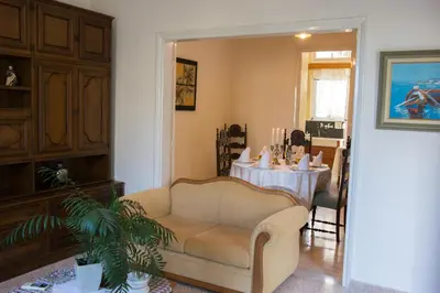 a living room with a table and a couch and a chair at Alexandra Apartment Near Chania Center in Chania Town