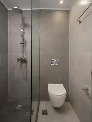 a bathroom with a toilet and a glass shower at Central City Hotel in Chania Town