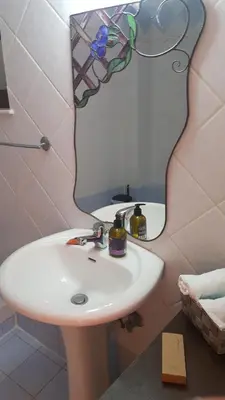 a bathroom with a white sink and a mirror at Estrella Studios in Chania Town