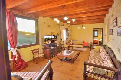 a living room with a couch and a television at Villa Athina in Kissamos