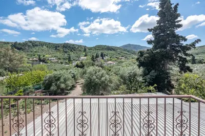 a view from the balcony of a villa with a tree at Achilleas Deluxe House-Jacuzzi - BBQ in Kotsianá