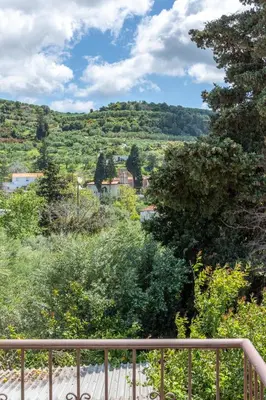 a view from a balcony of a town with trees at Achilleas Deluxe House-Jacuzzi - BBQ in Kotsianá