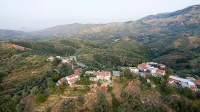 an aerial view of a village on a mountain at Ortaki Traditional House in Loúlos