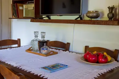 a table with a white table cloth and fruit on it at The Olive House in Kondomari