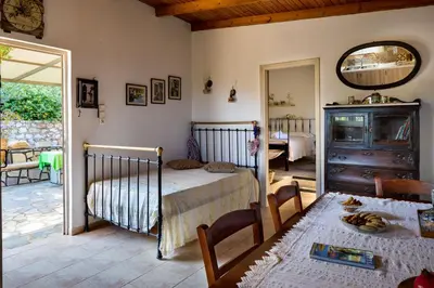 a bedroom with a bed and a table and a mirror at The Olive House in Kondomari